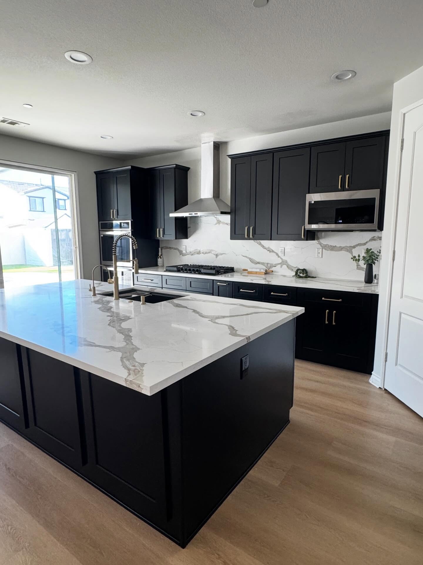 Alexandria Virginia kitchen after remodeling with white cabinetry, navy island and open dining sightline