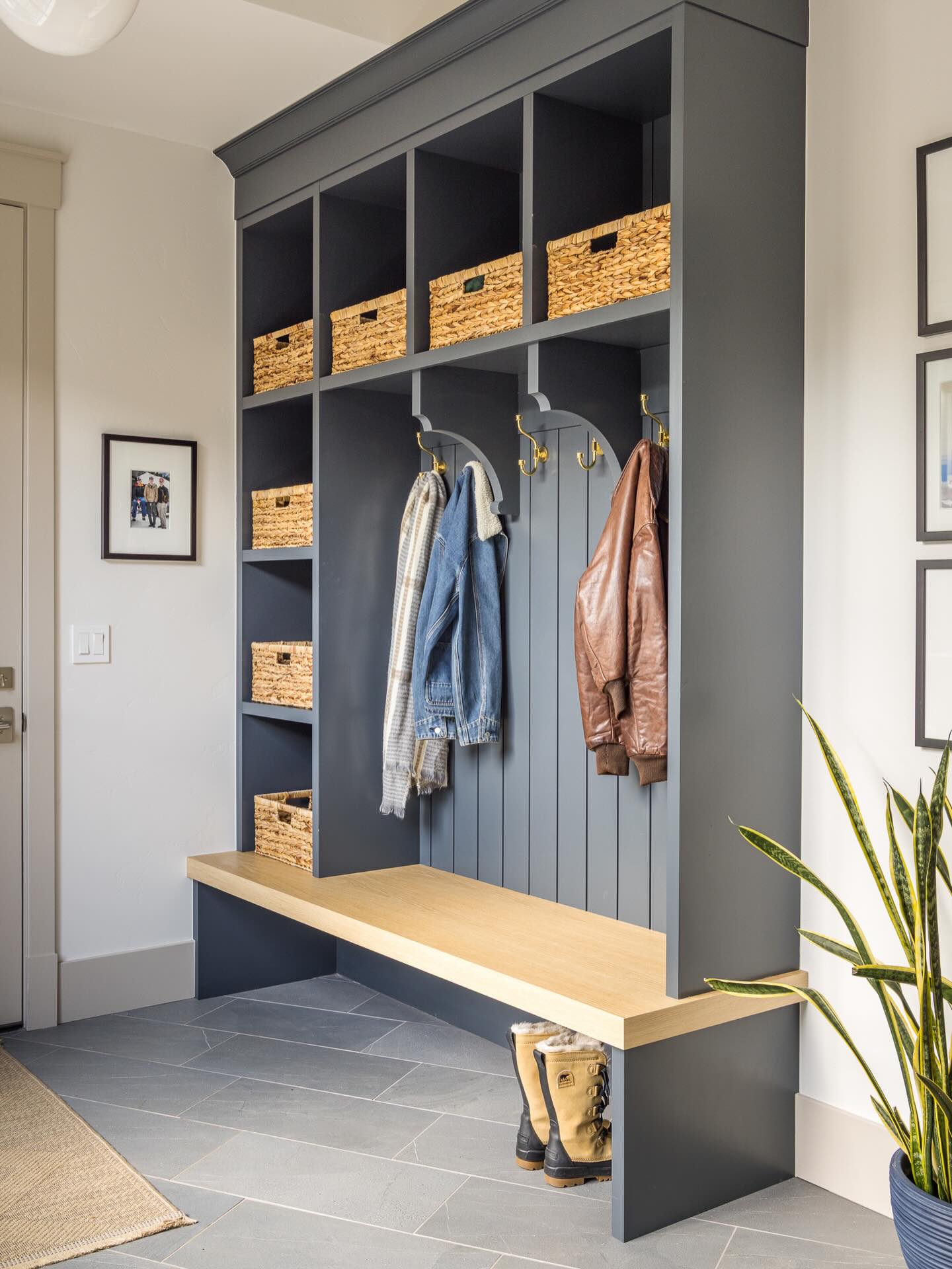 Charcoal mudroom locker unit with oak bench and woven storage baskets
