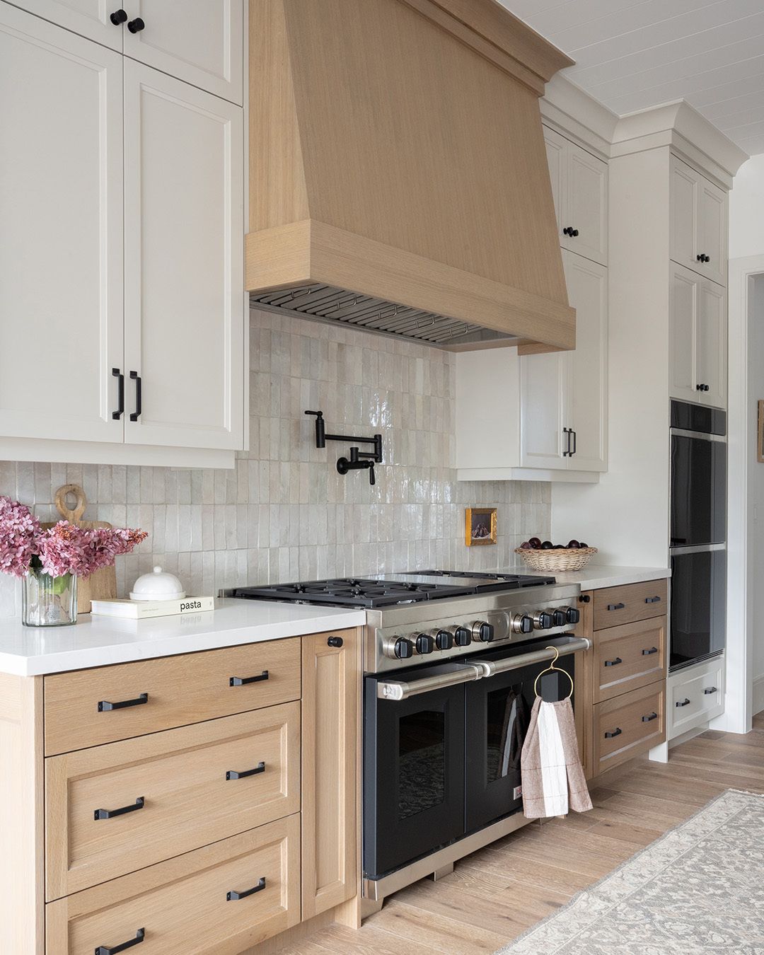 Remodeled kitchen with two-tone cabinetry, quartz counters and pendant lighting