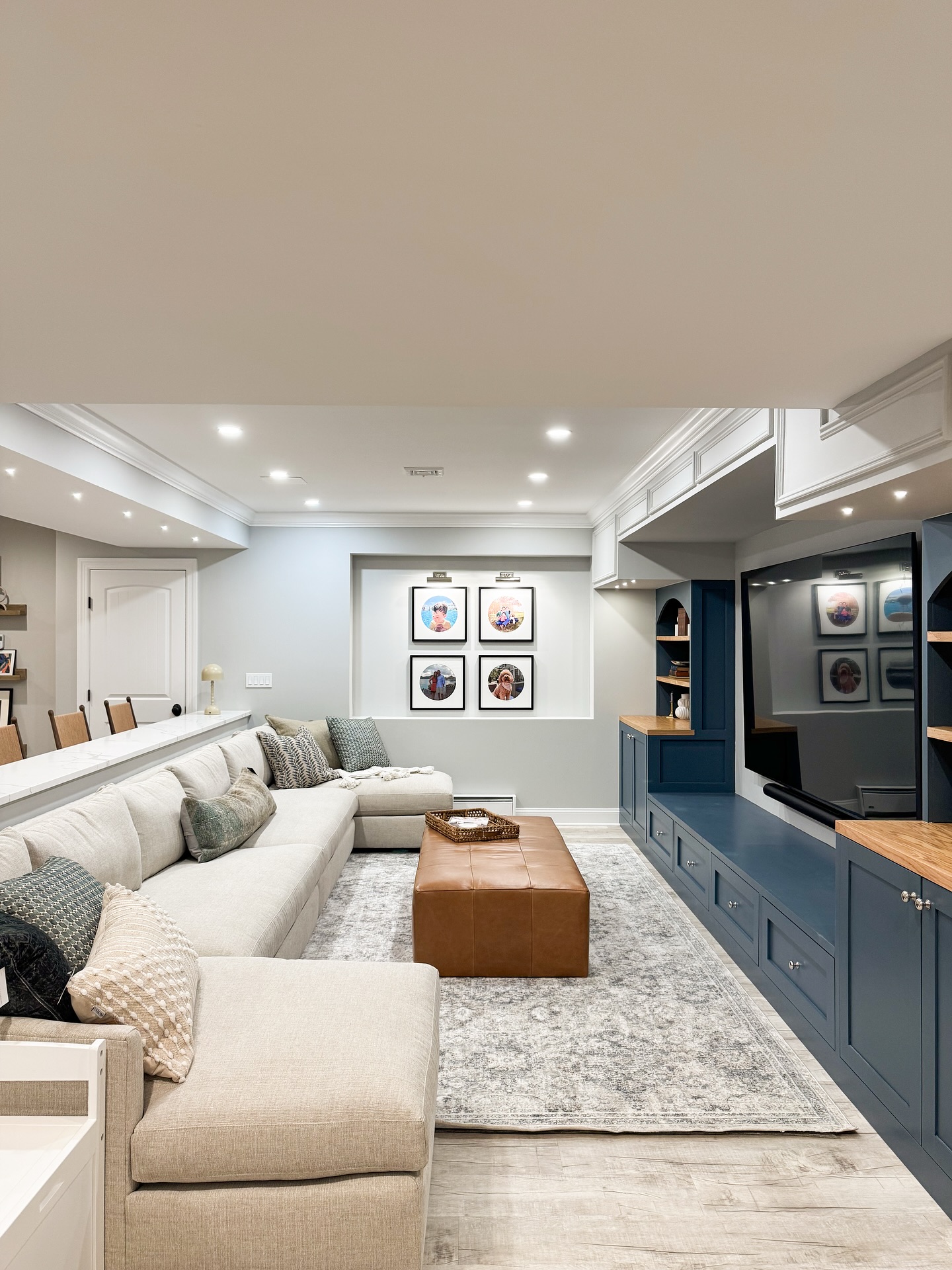 Renovated home interior with open staircase, white oak treads and view into the kitchen