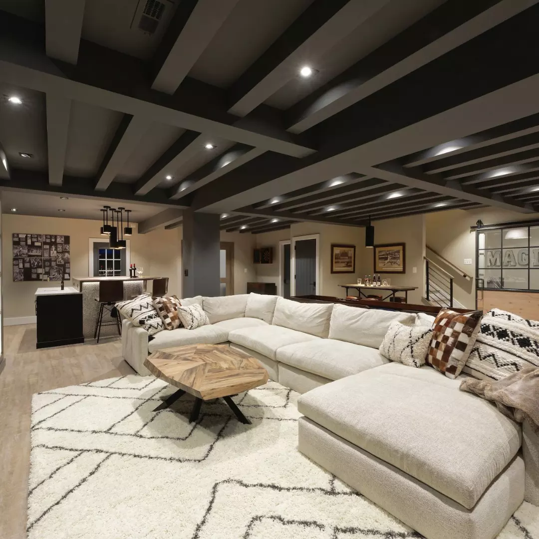 Finished basement with custom navy wet bar, quartz counter and lounge seating