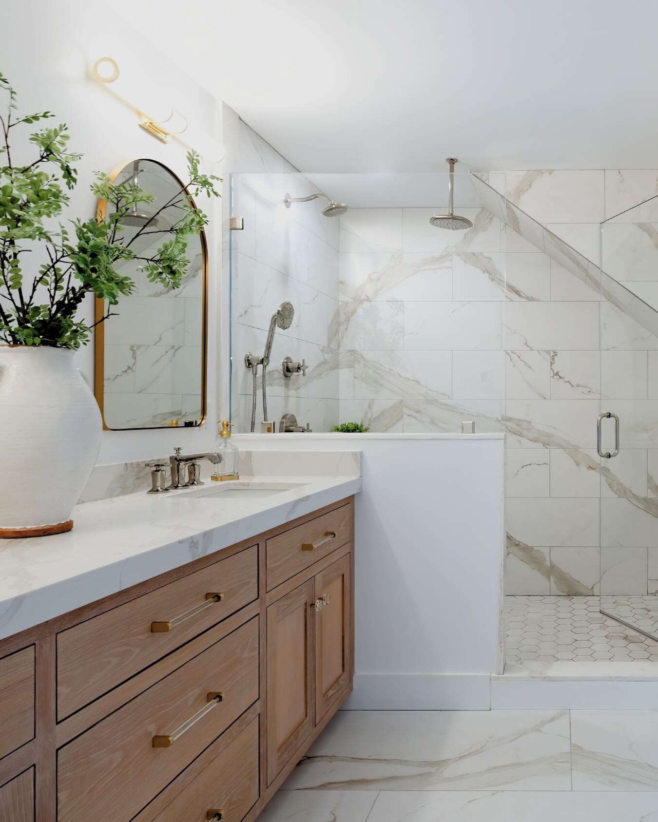 Remodeled primary bathroom with frameless glass walk-in shower and freestanding tub